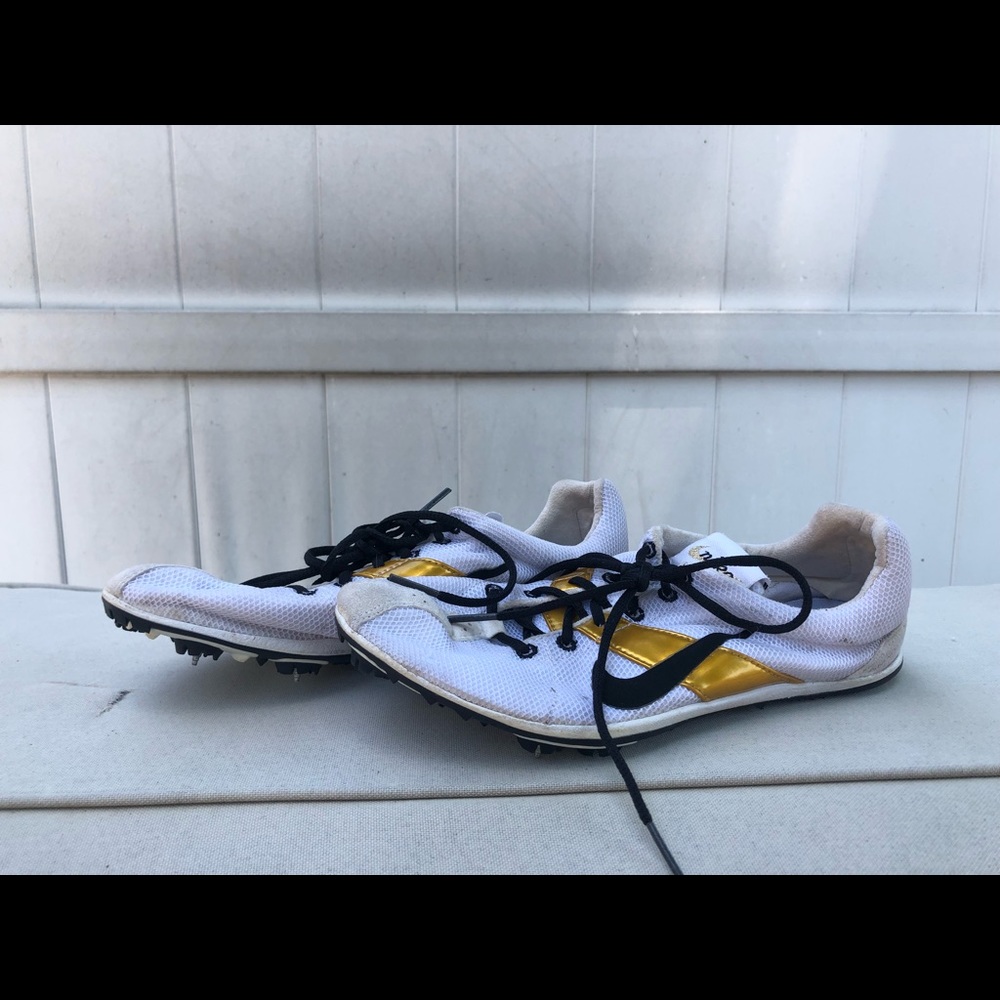 Black white and gold nike running spikes